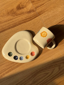 Overhead view of the palette-shaped saucer and espresso mug laid on its side