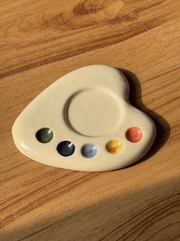 Cream artist palette saucer with green, navy, blue, yellow and coral paint dots