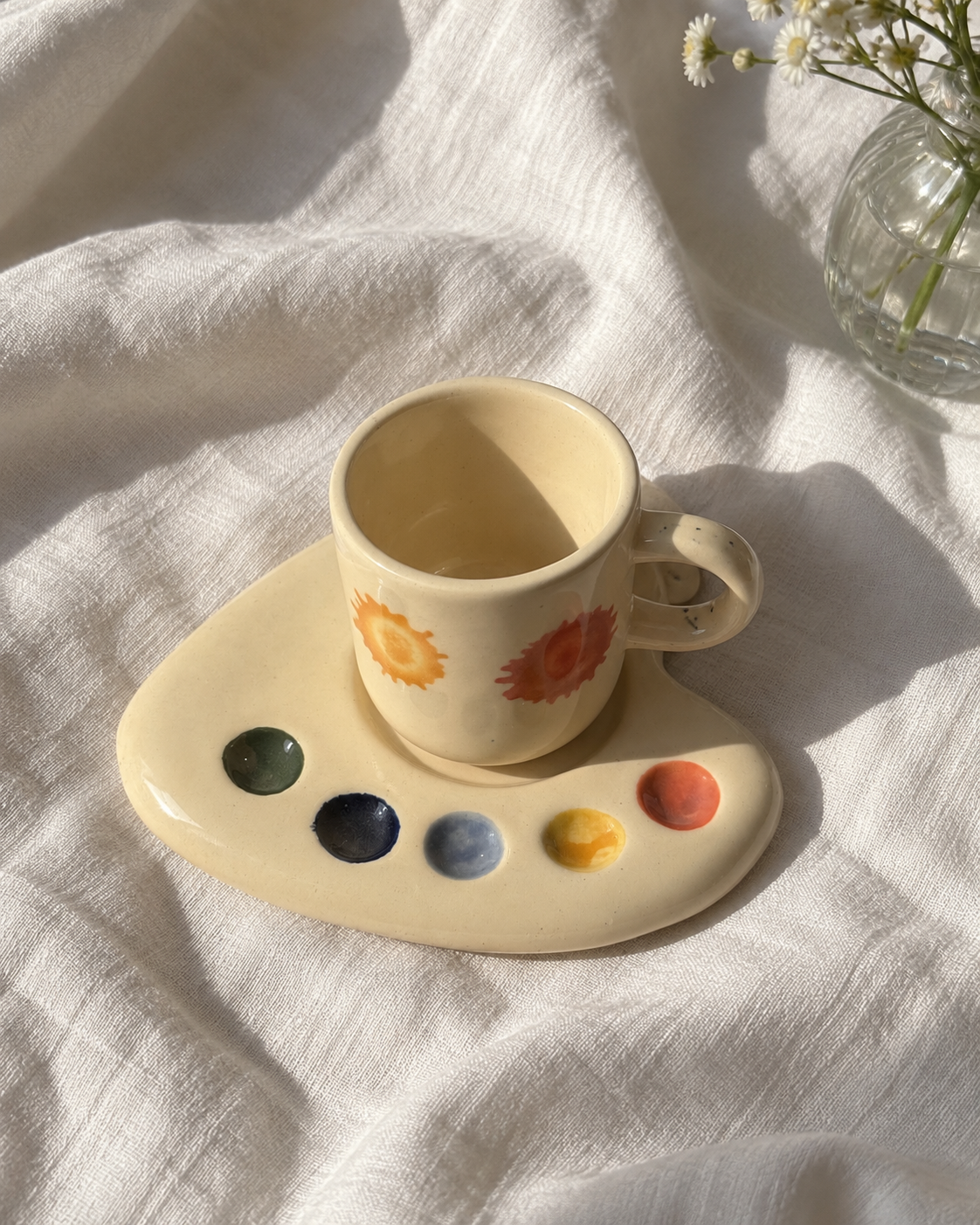 Overhead view of the Artist Palette espresso mug and saucer with five colourful paint dots