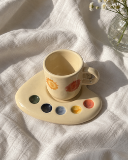 Overhead view of the Artist Palette espresso mug and saucer with five colourful paint dots