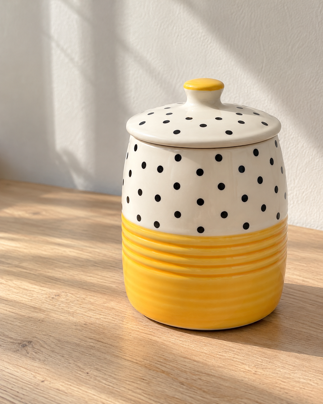 Yellow Polka Dot Ceramic Storage Jar, photographed in natural sunlight