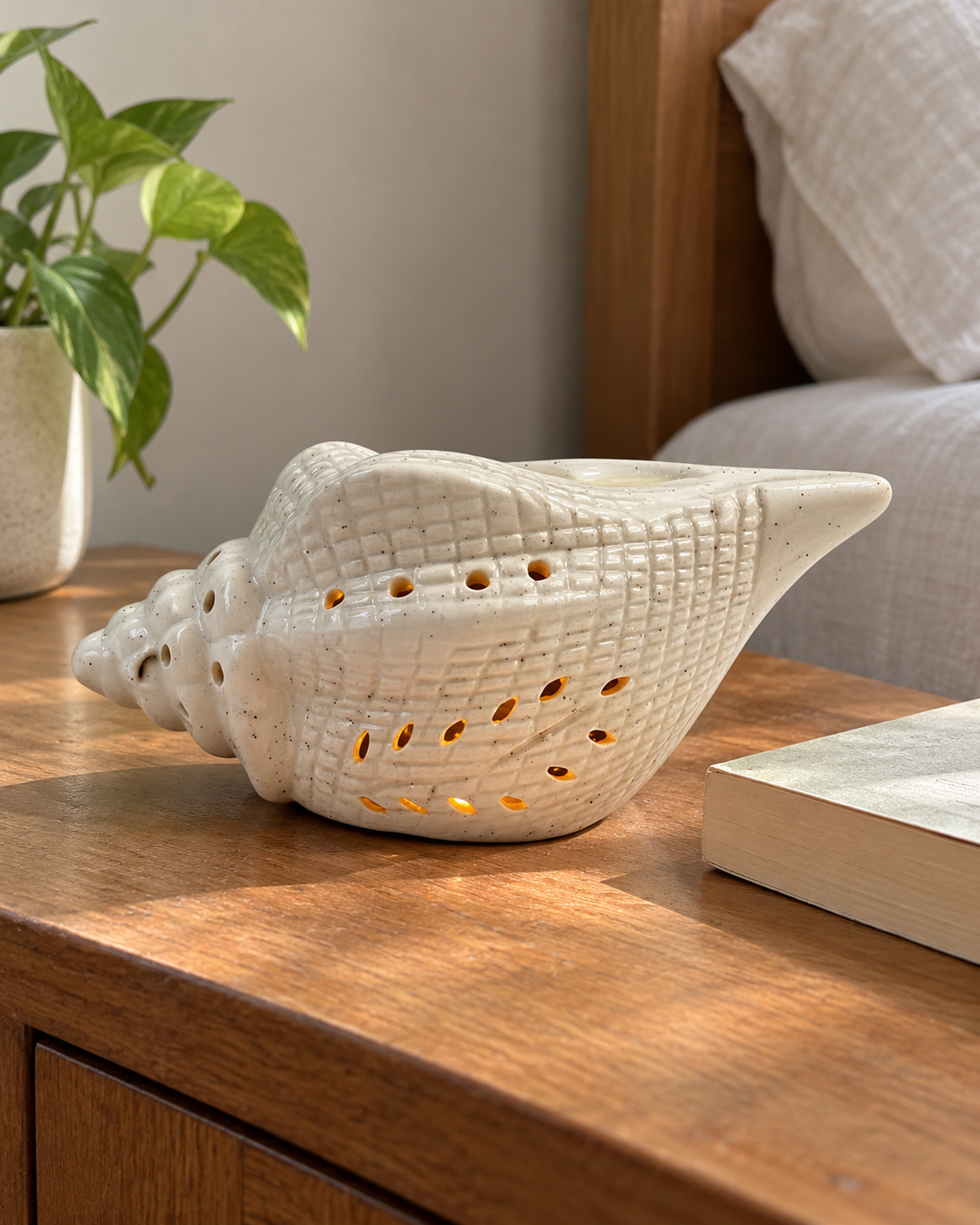Conch Shape Electric Ceramic Aroma Diffuser, styled in a home setting