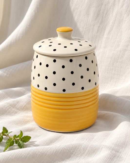 Yellow Polka Dot Ceramic Storage Jar, displayed on fabric