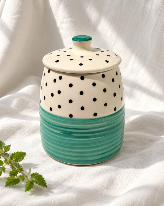 Green Polka Dot Ceramic Storage Jar, displayed on fabric