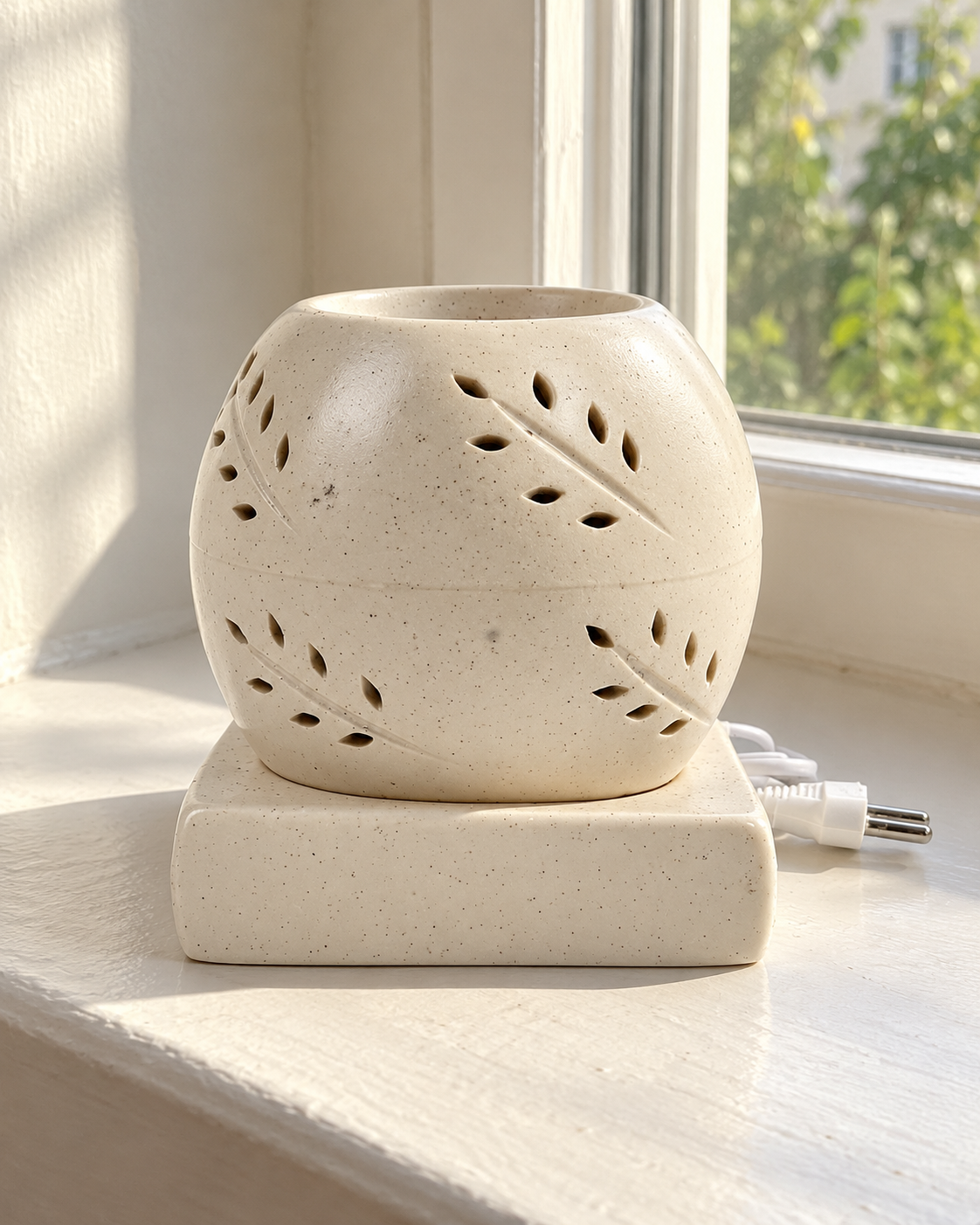 Coconut Shape Electric Ceramic Aroma Diffuser, photographed in natural sunlight
