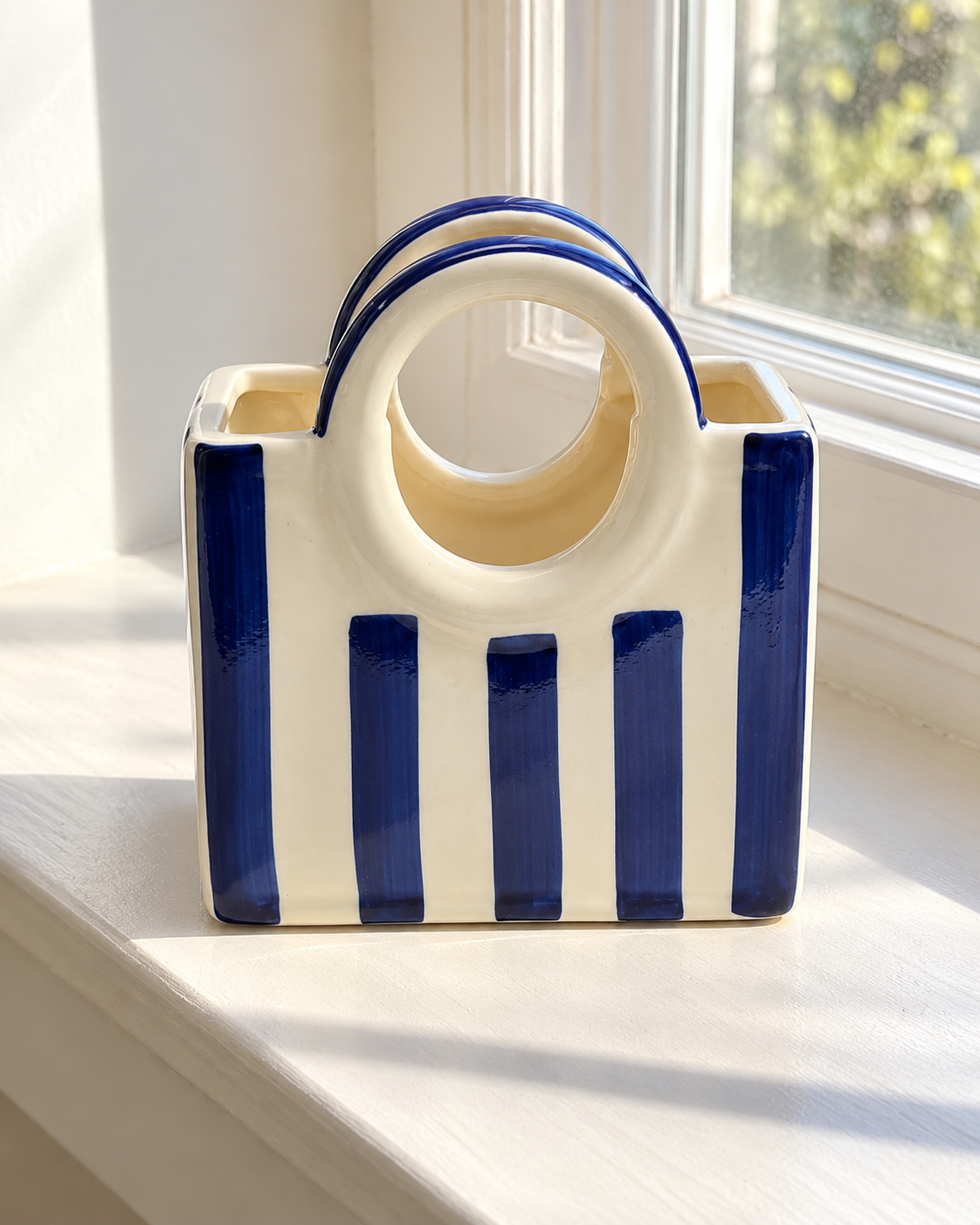 Blue Striped Ceramic Basket Vase, photographed in natural sunlight