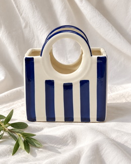 Blue Striped Ceramic Basket Vase, displayed on fabric