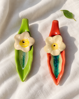 Leaf and Flower Ceramic Incense Holders - Red and Green, Set of 2, displayed on fabric