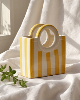 Yellow Striped Ceramic Basket Vase, displayed on fabric
