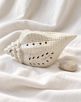 Conch Shape Electric Ceramic Aroma Diffuser, displayed on fabric