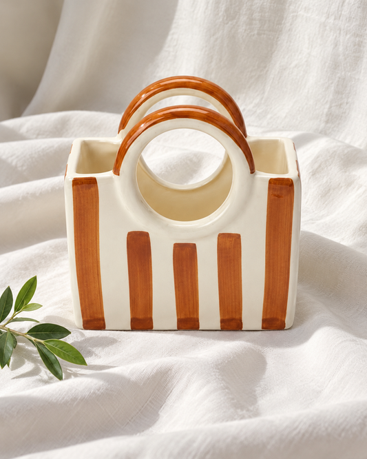 Brown Striped Ceramic Basket Vase, displayed on fabric