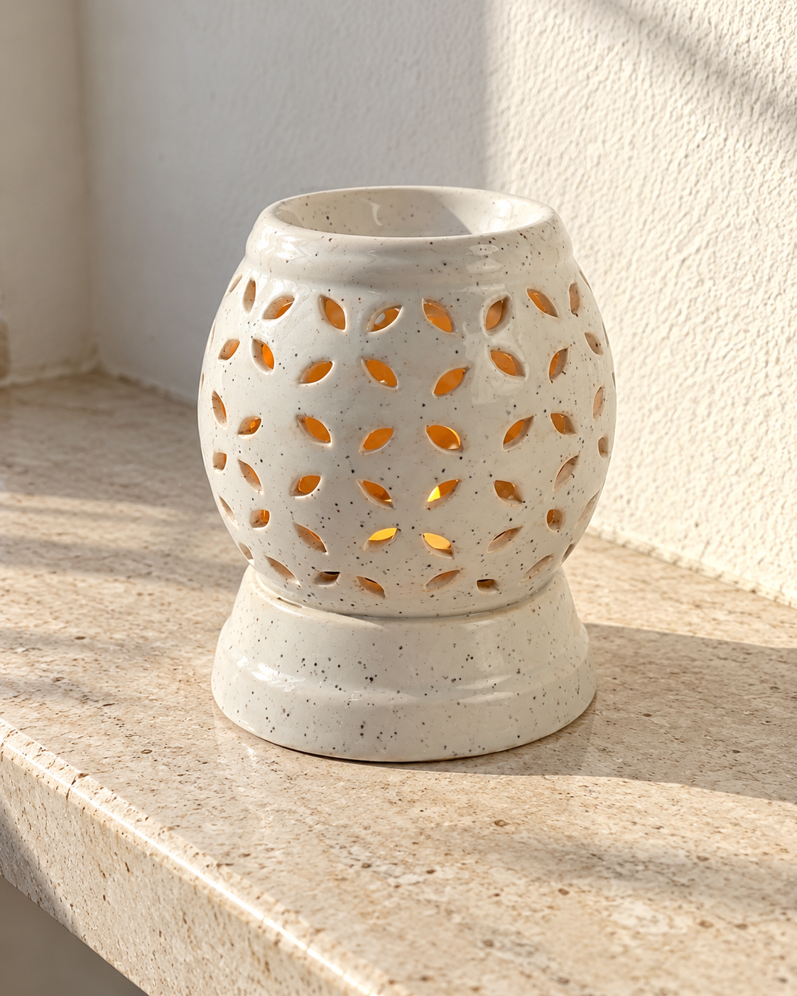 Round Cutwork Electric Ceramic Aroma Diffuser, photographed in natural sunlight