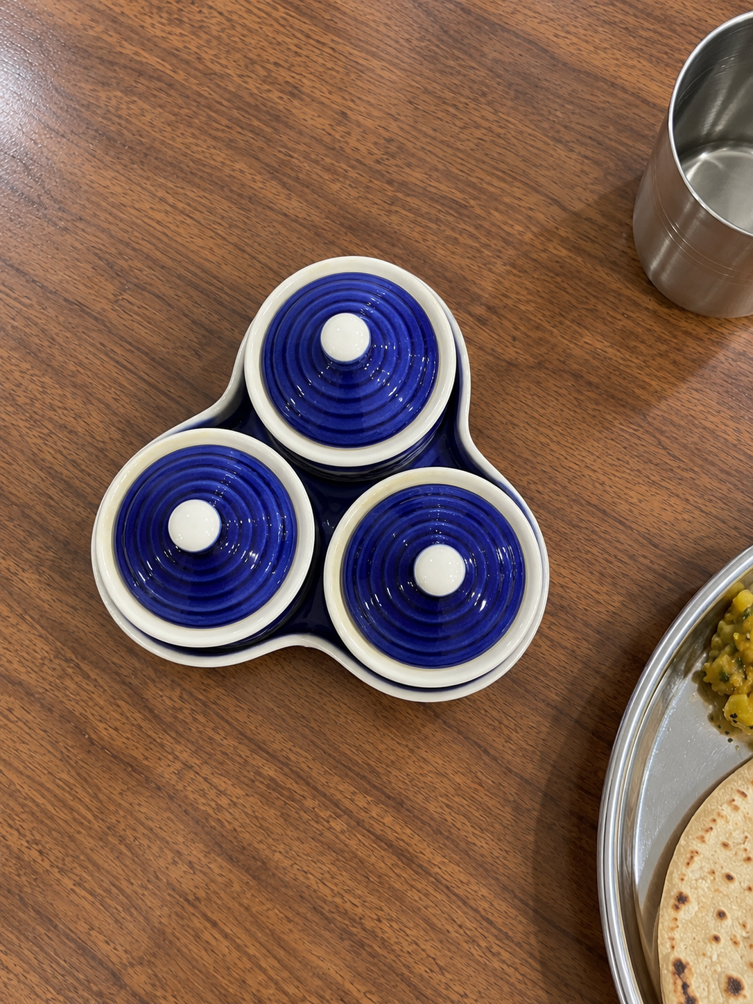 Blue Floral Ceramic Jar Set of 3 — overhead view on a dining table
