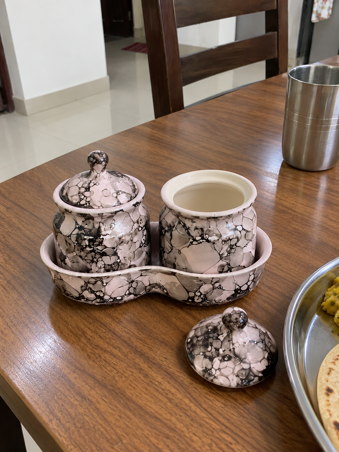 Blush Grey Marble Ceramic Jar Set of 2 — open detail view on a dining table