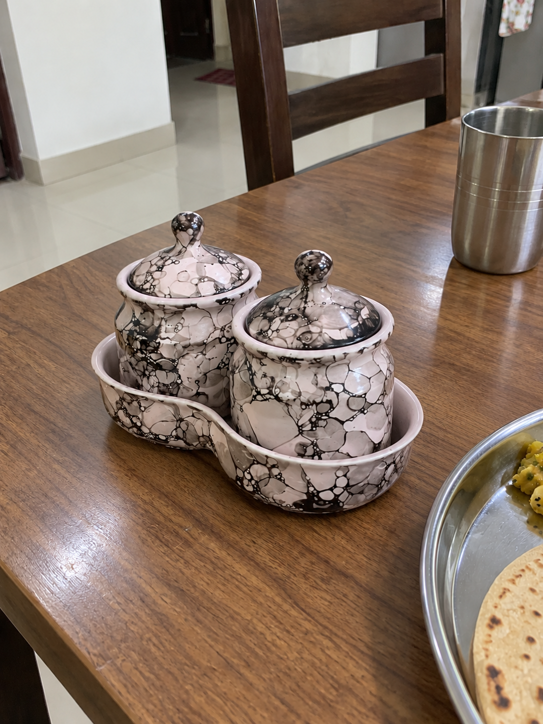 Blush Grey Marble Ceramic Jar Set of 2 — side view on a dining table