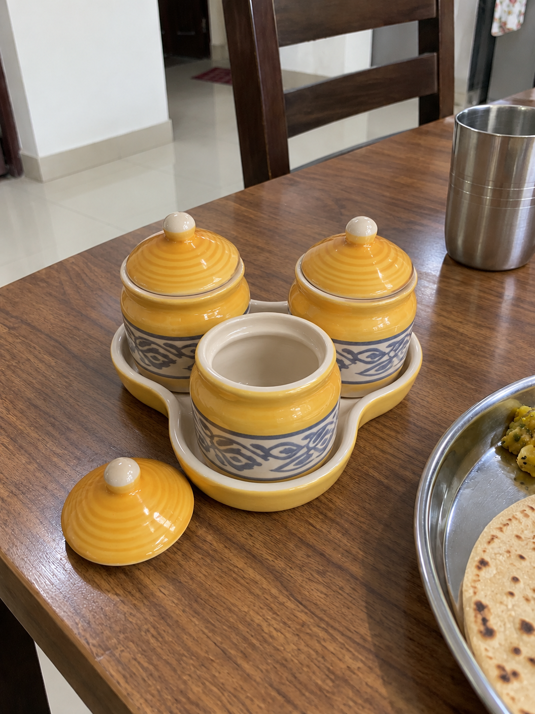 Yellow Floral Ceramic Jar Set of 3 — open detail view on a dining table