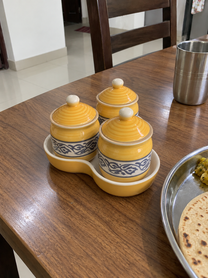 Yellow Floral Ceramic Jar Set of 3 — side view on a dining table